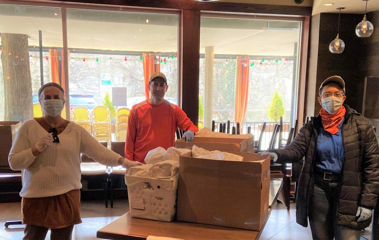 Anthony Gambino, owner of Cucina Paradiso, with volunteer food delivery folks Jean and Michelle